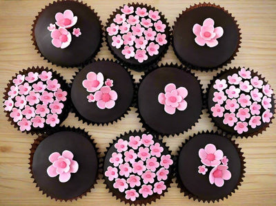 Chocolate Cupcakes - 10 Piece — pink floral decorations on dark cupcake tops; India