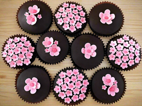 Chocolate Cupcakes - 10 Piece — pink floral decorations on dark cupcake tops; India