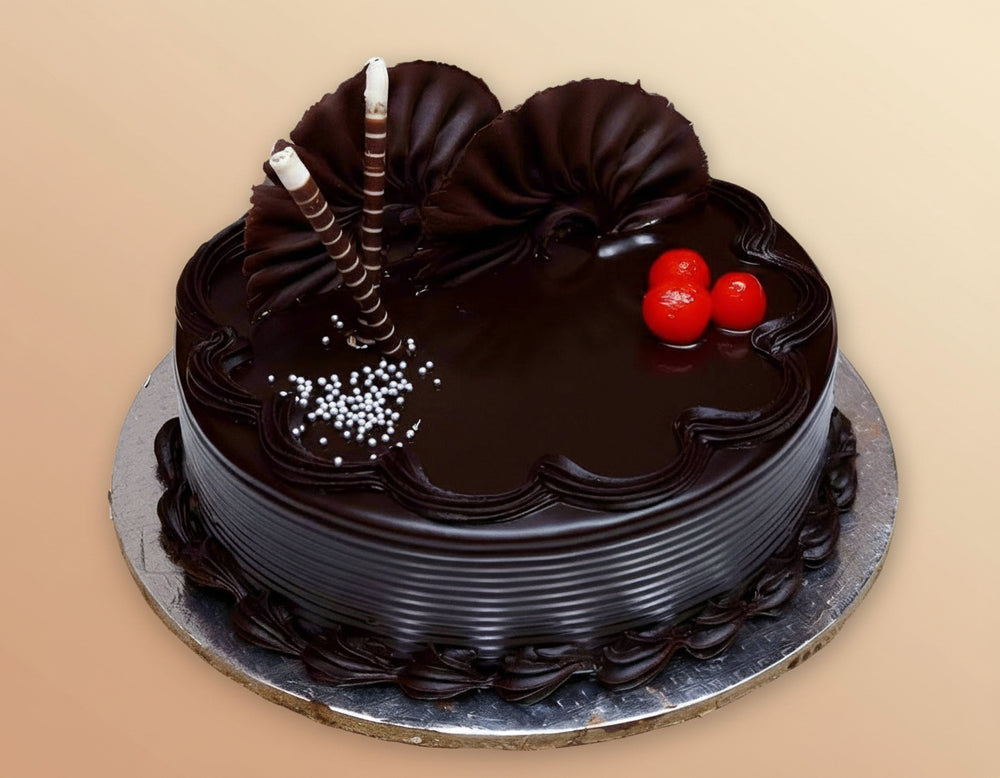 Chocolate Flower Cake — dark glaze, red cherries and fan-shaped topping pieces; India