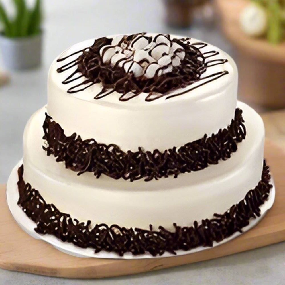 Crumb Finish Black Forest Cake — white cream finish, dark crumb bands and curled topping decorations; India