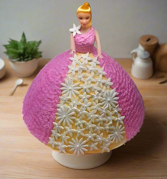 A cake designed to look like a Barbie doll with a pink and yellow color scheme, serving a large number of people. Across the canada