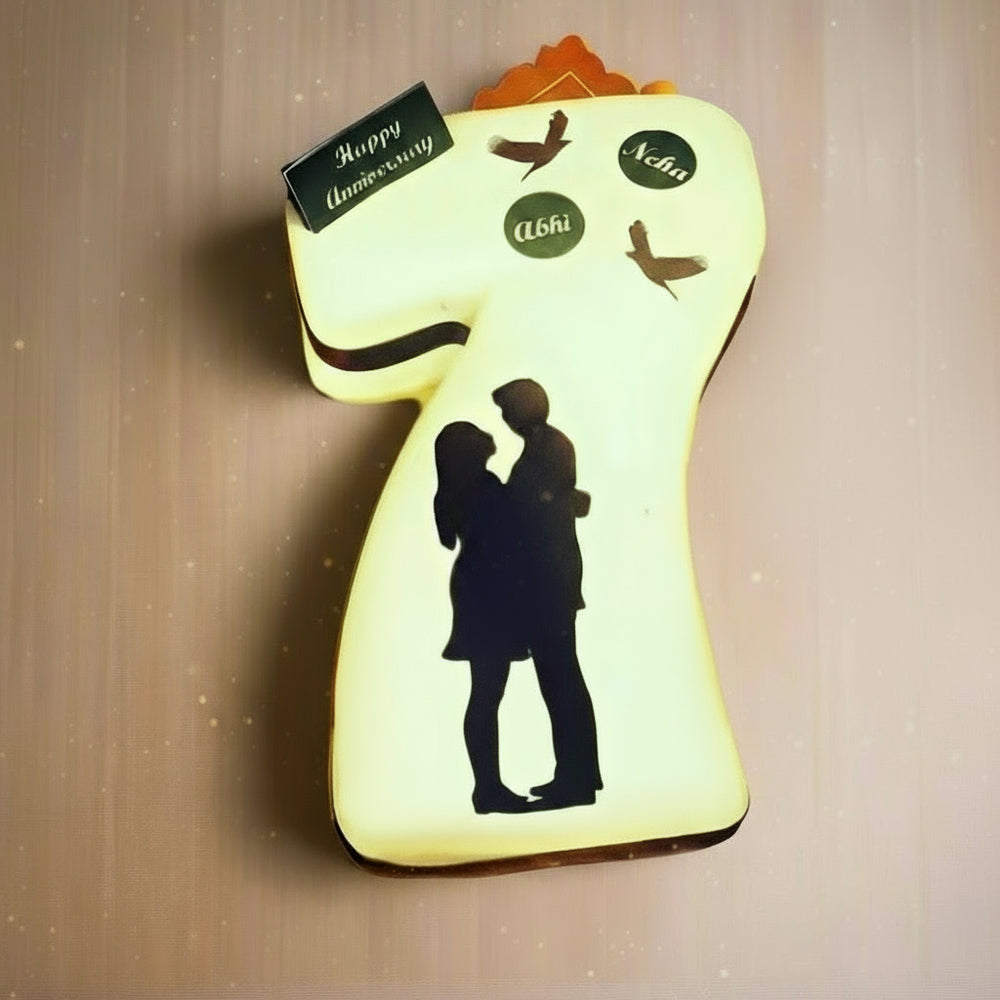 7th Anniversary Cake — a pale green number 7 with couple silhouette detailing; India
