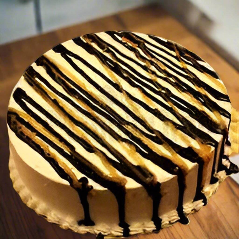 Butterscotch Cake with Chocolate Stripes — golden cream finish with dark striped drizzle; India
