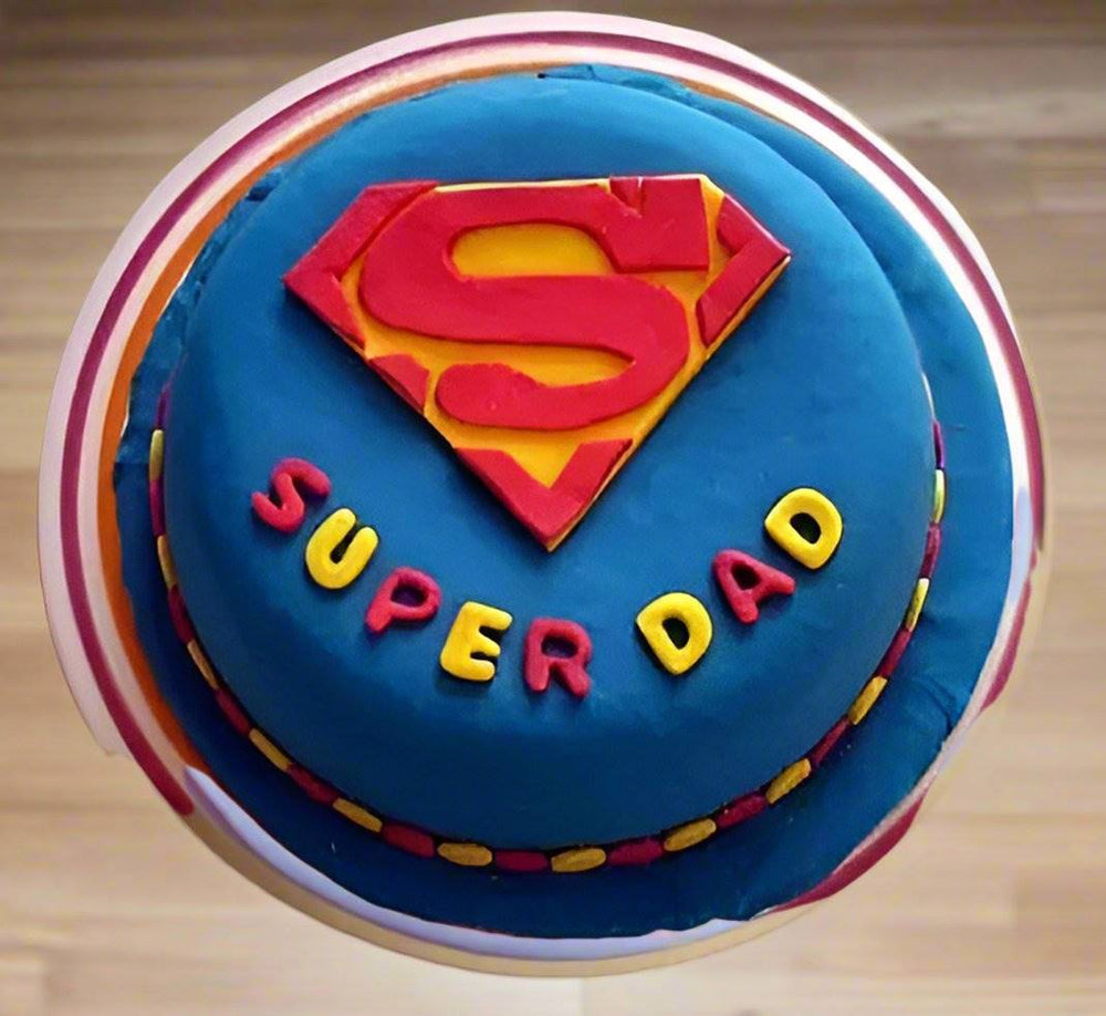 Super Dad Emblem Cake — blue Superman-style dad design with red and yellow detailing; India