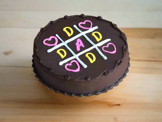 Dad Noughts and Crosses Cake — dark finish and a colourful dad-themed noughts-and-crosses motif; India