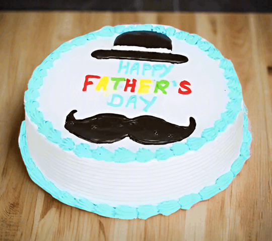 Blue Moustache Father's Day Cake — white-and-blue finish with a moustache motif and dad greeting; India