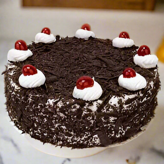 Shaving Decor Black Forest Cake — dark chocolate shavings, white cream dollops and red cherries; India