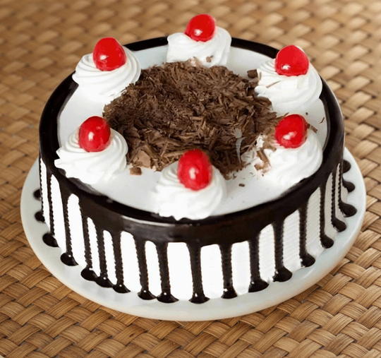 Drip Finish Black Forest Cake — dark drip sides, white cream and a chocolate-shaving centre; India