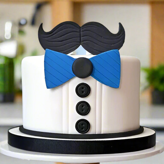 Father Bow Tie and Moustache Cake — shirt-and-bow-tie design with dark buttons and moustache motif; India