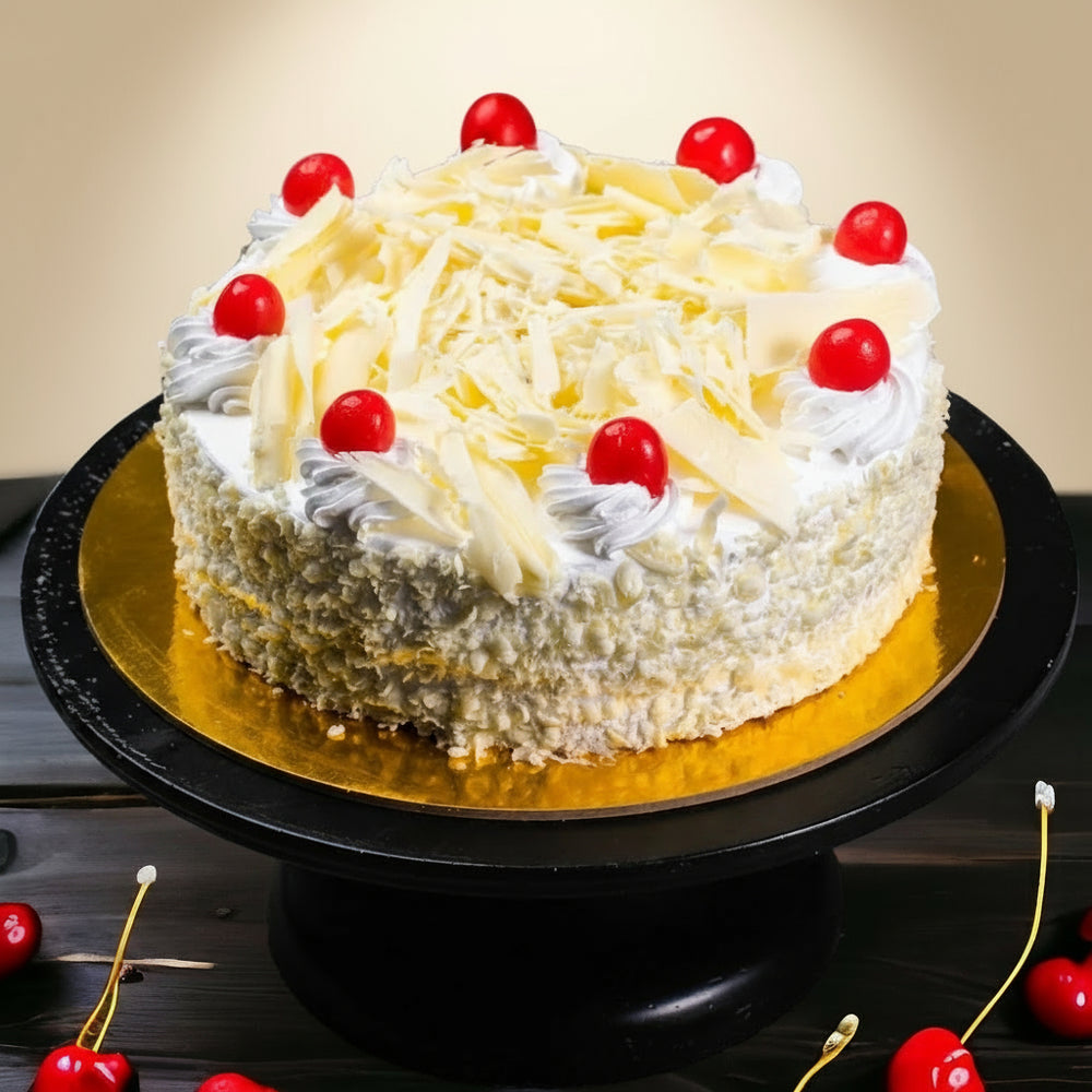Shaving Decor White Forest Cake — pale shavings, white cream dollops and red cherries; India