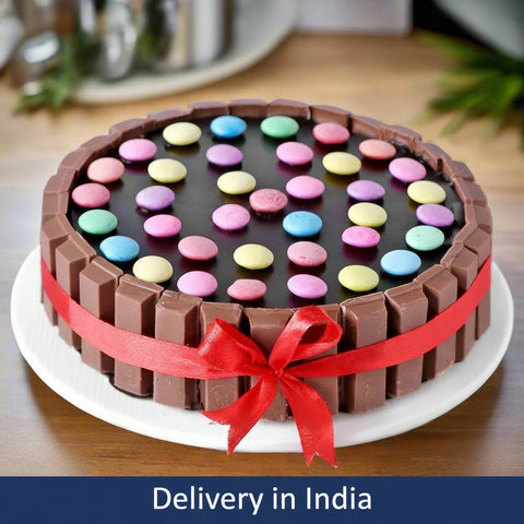 Chocolate Cake with Gems & Kitkat – India — chocolate-bar sides, coloured candy topping and a red ribbon; India