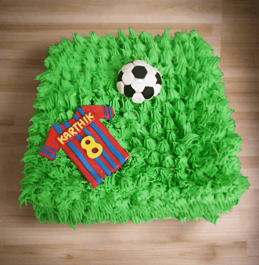 Football Shirt Player Cake — green football-field piping with a ball and shirt motif; India