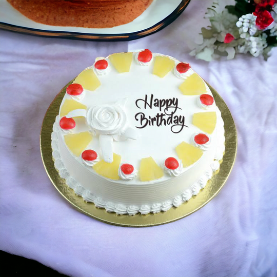 Pineapple Birthday Cream Cake — white cream topping, pale fruit pieces and red cherries; India