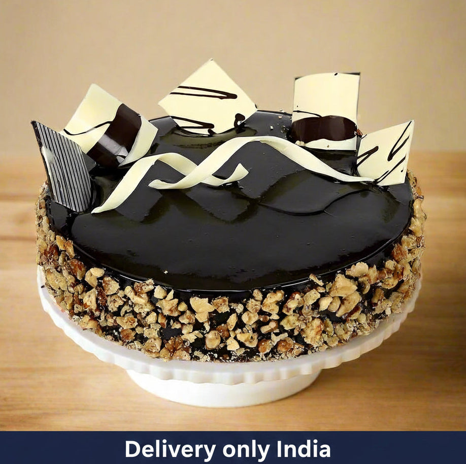 Celebration Chocolate Nutty Cake — nut-covered sides and broad dark-and-pale curled decorations; India