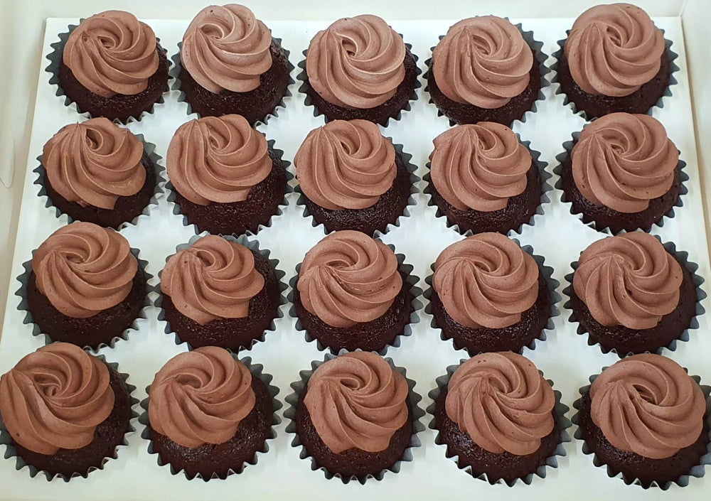 Chocolate Cupcakes - 36 Pieces — brown piped swirls across a large cupcake arrangement; India