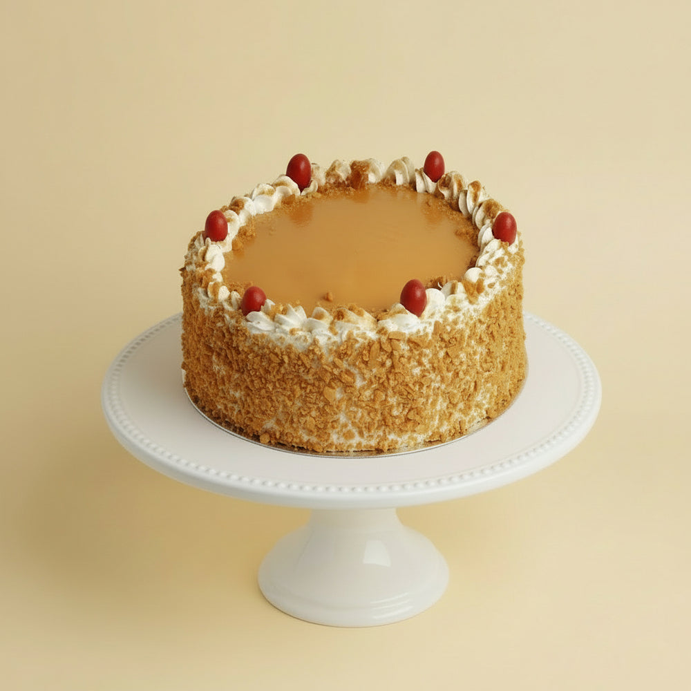 Celebration Butterscotch Cake — golden textured sides with a pale piped top border; India