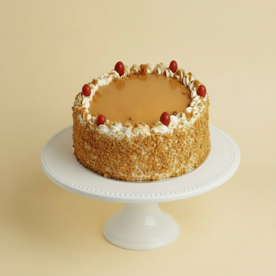 Celebration Butterscotch Cake — golden textured sides with a pale piped top border; India