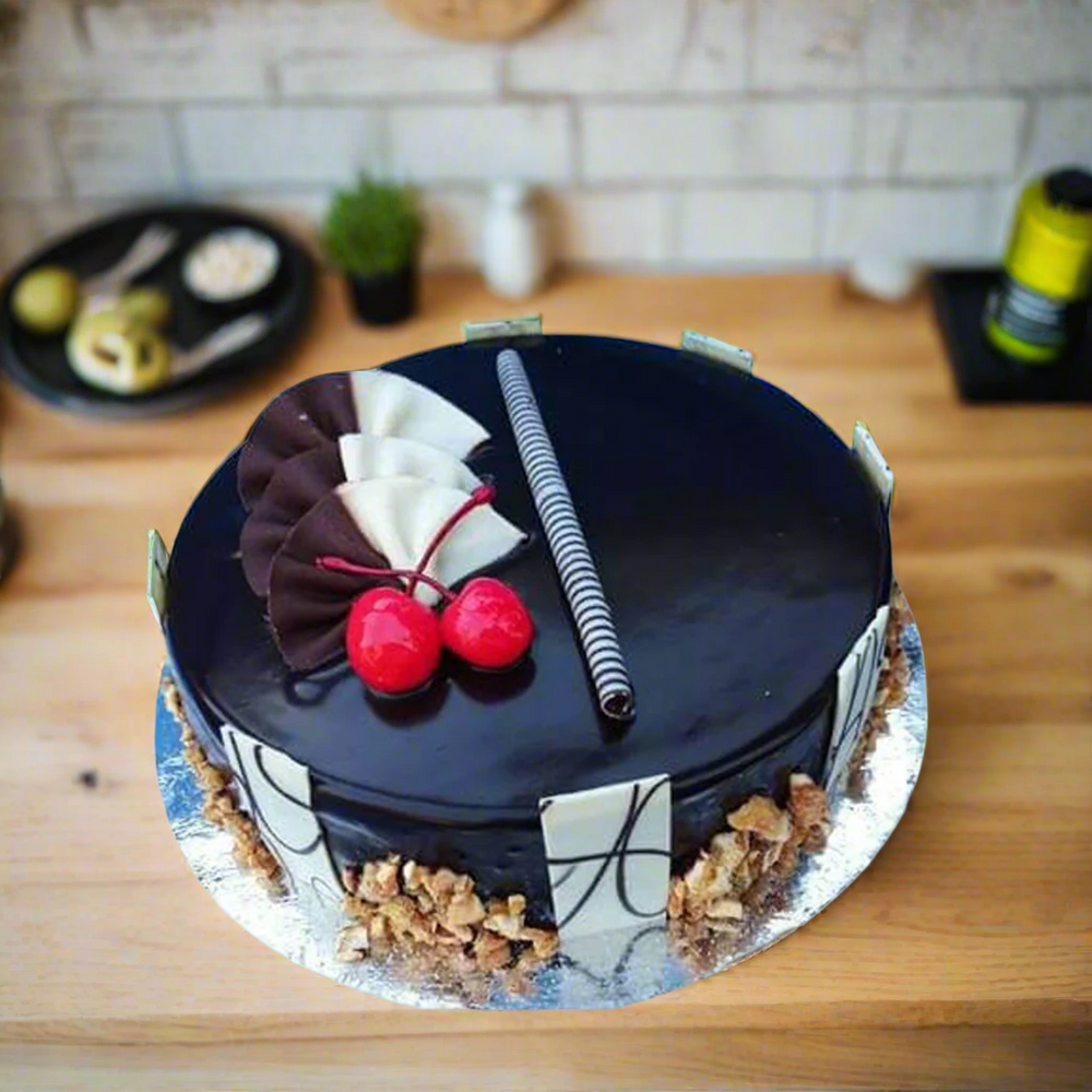Chocolate Walnut Cake — glossy dark finish, nut edging and cherry accents; India