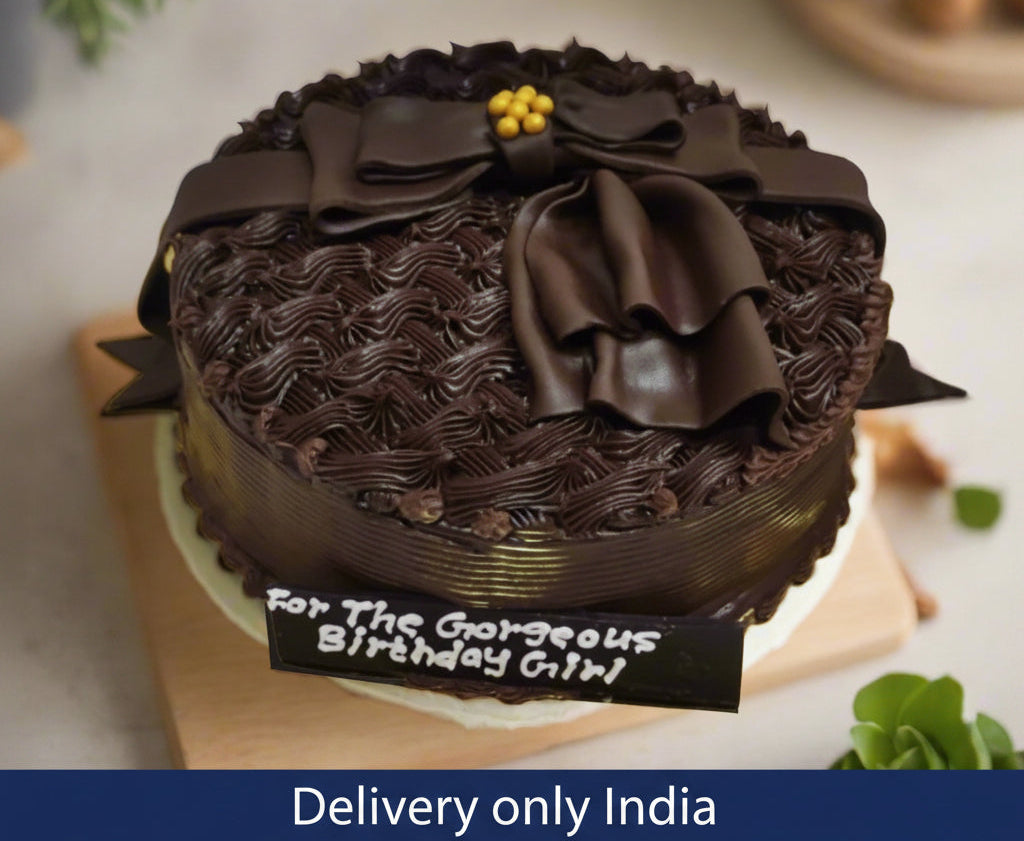 Premium Chocolate Cake — dark textured sides and chocolate-style bows and decorations; India