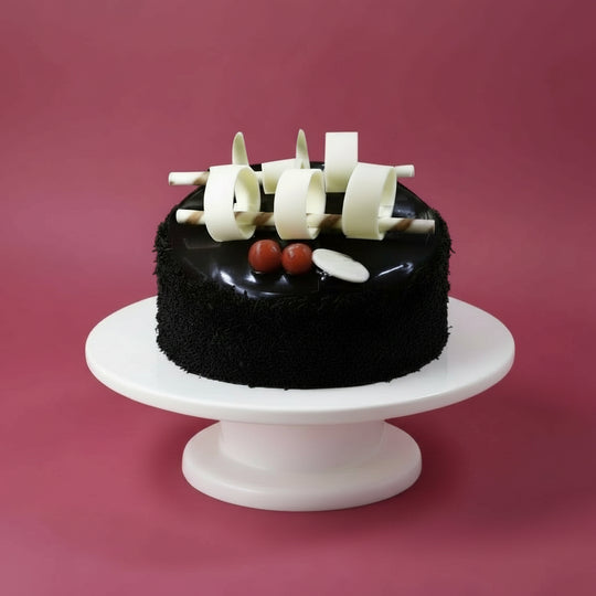 Chocolate Rice Cake — dark crumb finish and upright pale decorative pieces; India