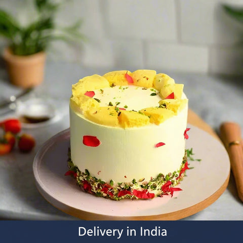 Rasmalai Cake 1 kg — smooth yellow finish with red-and-green accent decoration; India