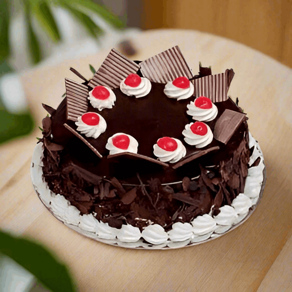 Black Forest Sweet Cake — dark side shavings, white cream and red cherries; India