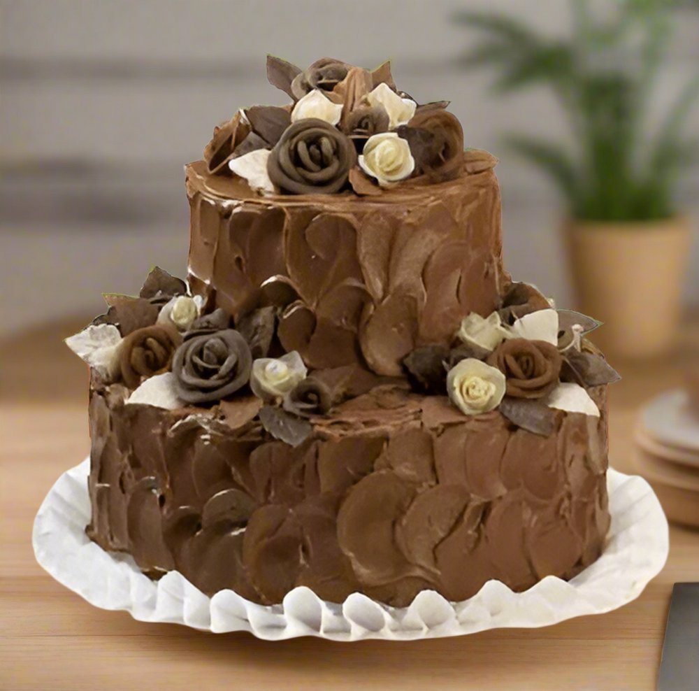 Dual Step Chocolate Cake — chocolate-coloured frosting and pale floral decoration; India