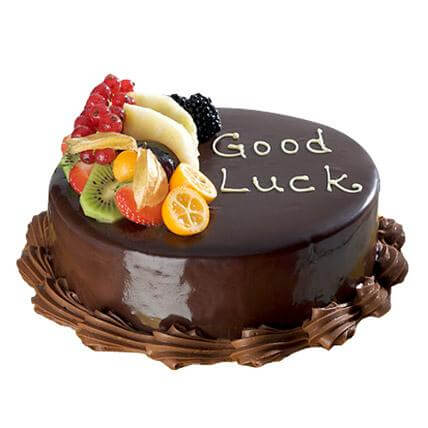 Fruit Topped Good Luck Cake — dark smooth finish, fruit cluster and good-luck lettering; India