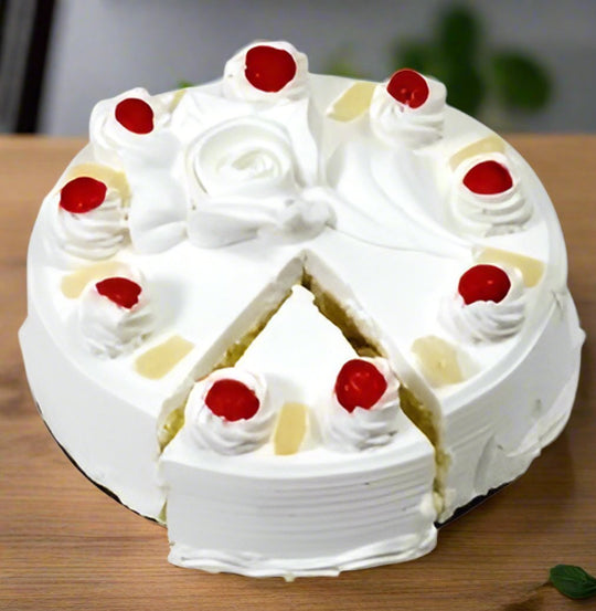 Rosette Pineapple Cakes — white cream rosettes and red cherry accents; India