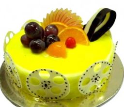 Yellow Fruit Celebration Cake — yellow finish, fruit cluster and green patterned side panels; India