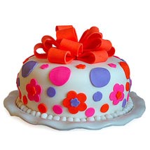 Gorgeous Cake — colourful spots, flower motifs and a large red bow; India