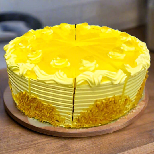 Exotic Pineapple Cake — yellow piped topping and textured golden sides; India