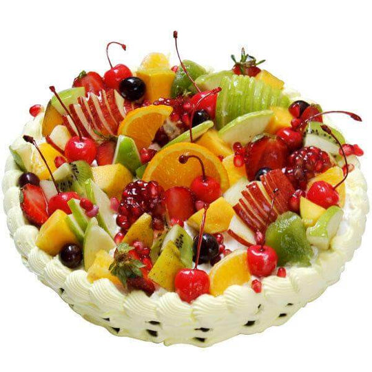 Mixed Fruit Basket Design Cake — a basket-style piped cream border and a generous mixed-fruit topping; India