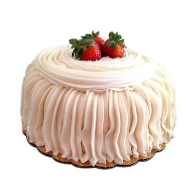 Waves Design Cake — white wave-style vertical piping and strawberry topping; India
