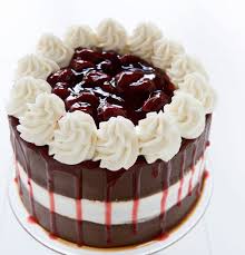 Tasty Chocolate Cake — cream topping, dark side panels and layered drip detailing; India