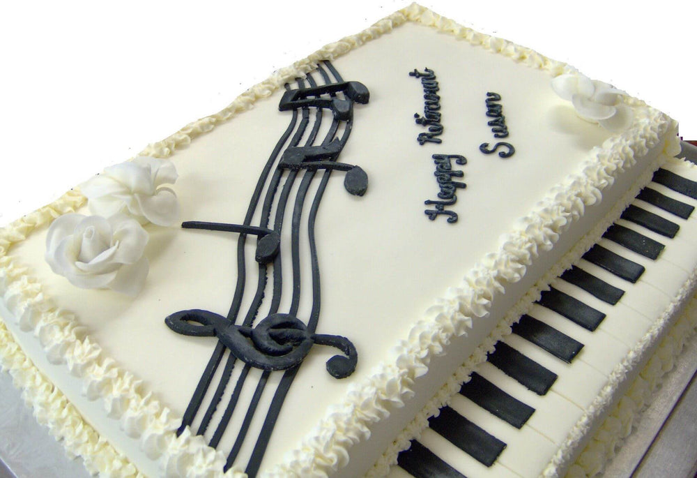 Piano Keys Music Cake — piano-key detailing and black musical-note decorations; India
