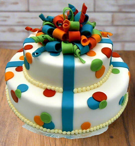 Gift Box Cake Design with Ribbons — ribbon-like bands, a colourful bow and polka dots; India