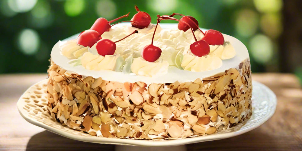 Loaded Nuts Special Cake — nut-covered sides, cream topping and cherry accents; India