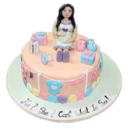 Waiting to See Cake — a seated figure and pastel baby-themed decorations; India