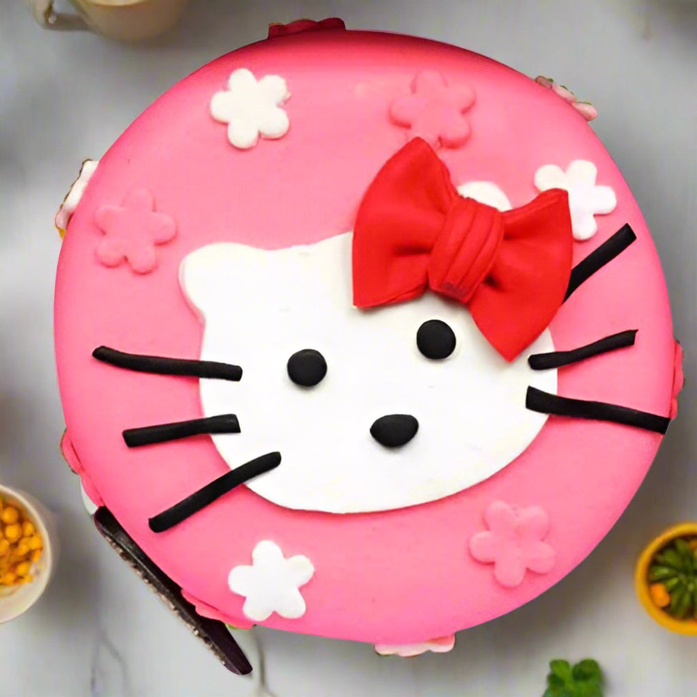 Hello Kitty Birthday Cake — pink Hello Kitty face with a red bow and flower motifs; India