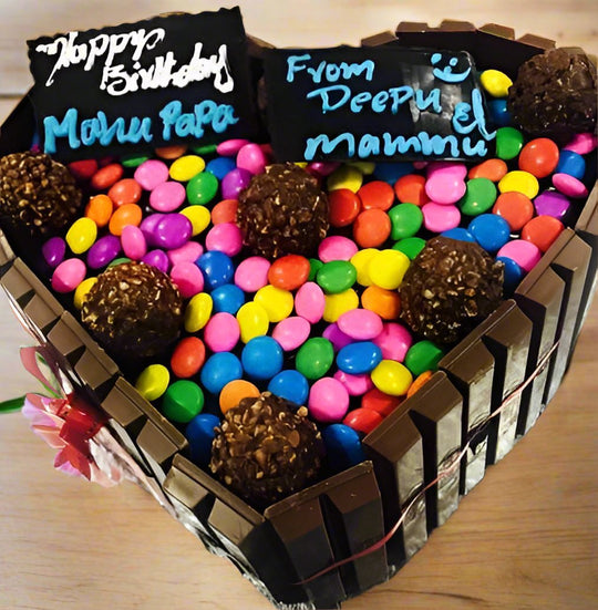 Three Variety Chocolate Cake — chocolate-bar sides, colourful candy topping and two message panels; India