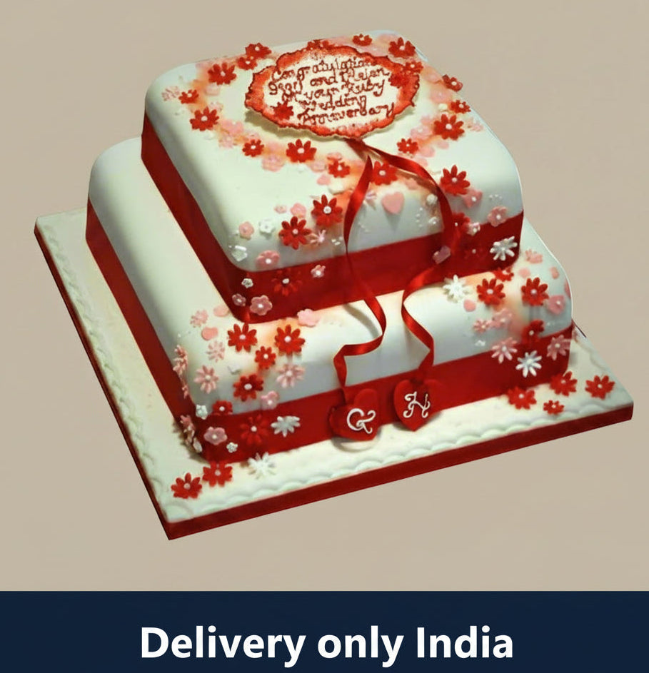 Anniversary Step Cake — white-and-red anniversary styling with floral accents; India
