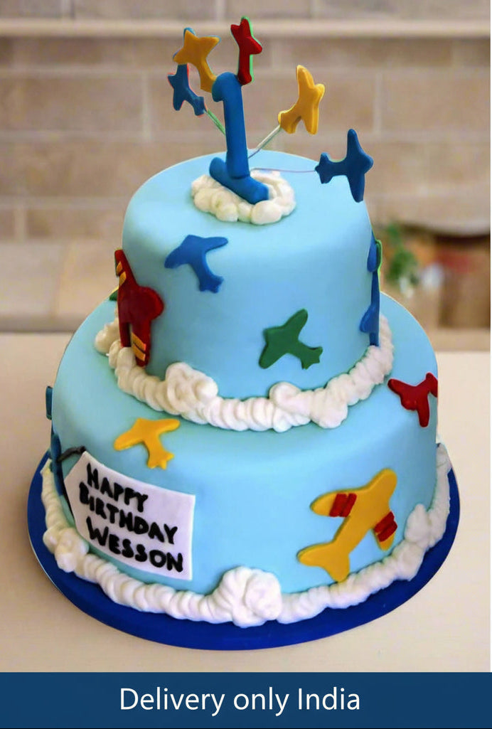 First Birthday Cake — blue first-birthday tiers with stars and number decorations; India