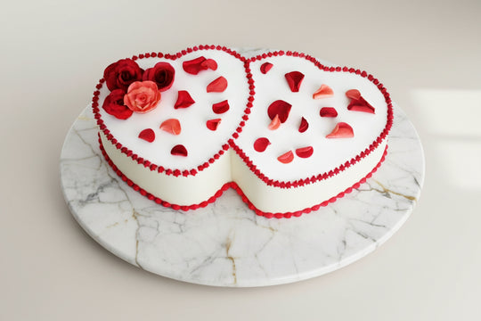 Valentine Decorated Cakes - Delicious Heart Shaped Cake — two white hearts with red piped edges and red heart accents; India