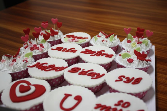 I Love You Cupcakes — red-and-white love-themed lettering on individual cupcakes; India