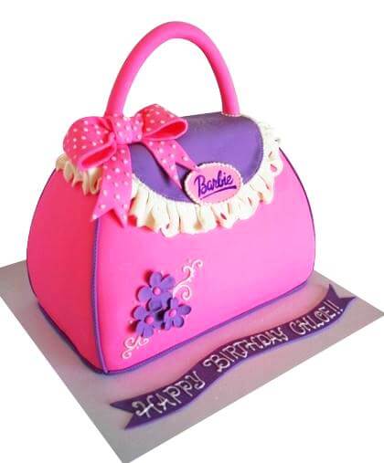 Handbag Cake — pink bag design with a curved handle and floral detailing; India