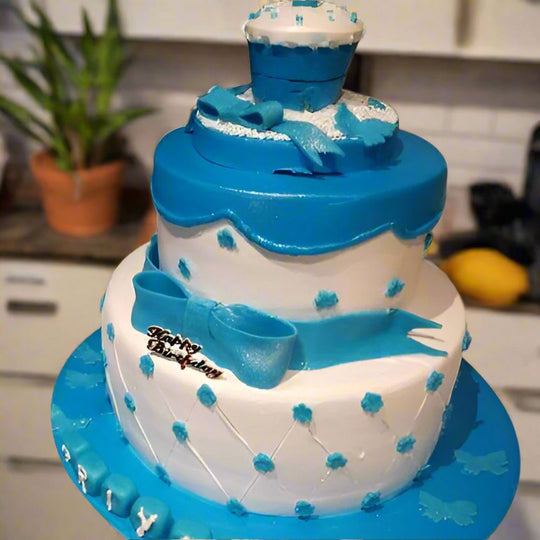 Blue and White Tiered Fondant Cake — alternating blue-and-white tiers with blue floral accents; India