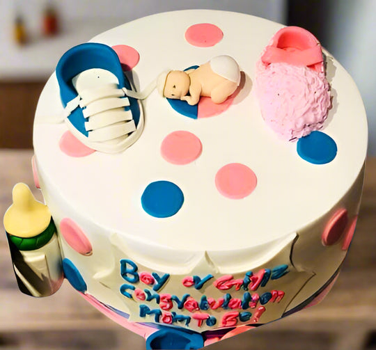Cake for Baby Shower — baby shoes and pink-and-blue baby-themed decorations; India