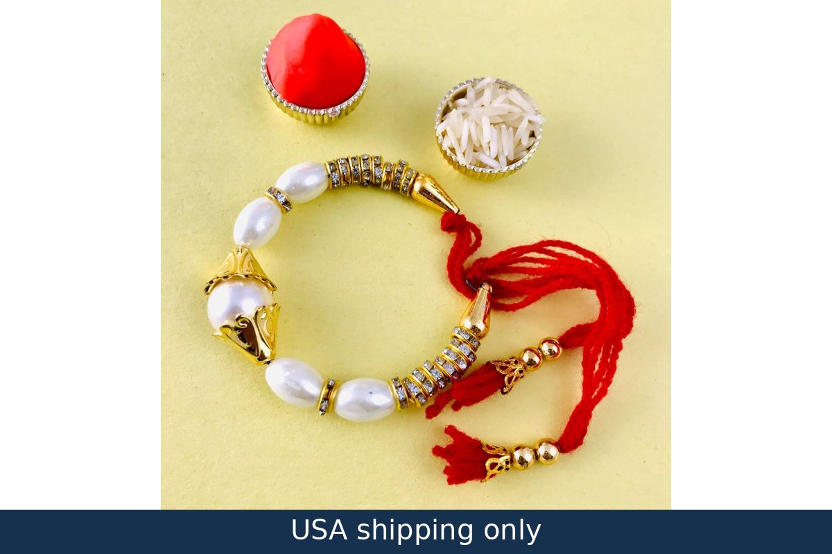 A bracelet with gold and silver colors featuring a mix of pearl-like beads and a red bead, complemented by a small red tassel and a silver spice container.