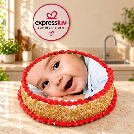 Photo Cake — a baby photo print with red piped border and golden sides; India